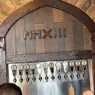 a man standing in front of a beer tap