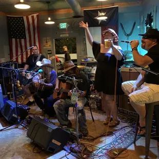 a group of people singing and playing instruments