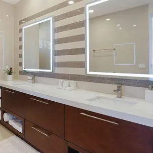 a modern bathroom with double sinks