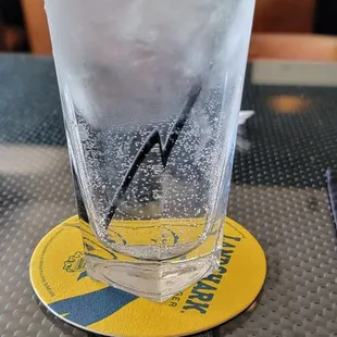 a glass of water with a lime wedge