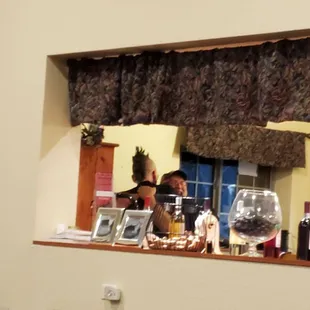 a man sitting at a table with a glass of wine