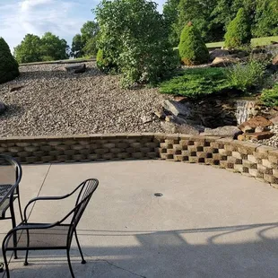 a patio with chairs and a table