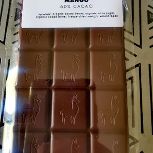 Made with 50/59 blend of cacao from Ecuador and Peru, this is 60% dark chocolate. Includes organic mango which gives it some spicy tones.