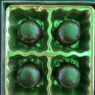 four chocolates in a green box