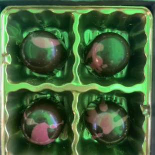 four chocolates in a tin