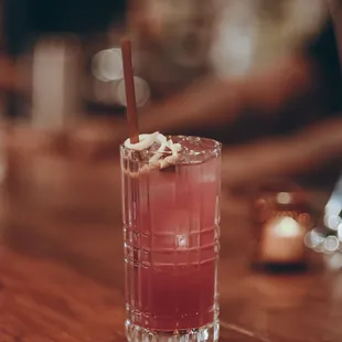 a pink drink with a straw