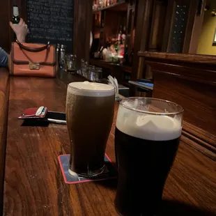 two glasses of beer on a bar