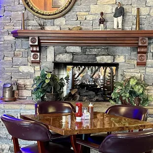 Tables on each side of two-side fireplace