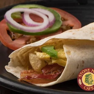 a breakfast burrito on a plate