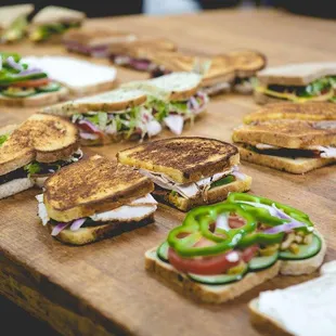 a variety of sandwiches on a cutting board