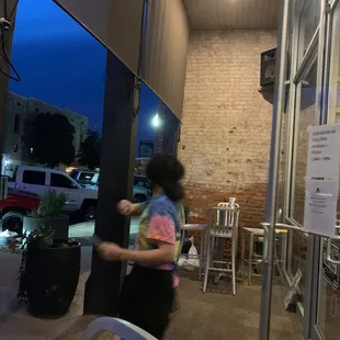 a woman walking down the sidewalk