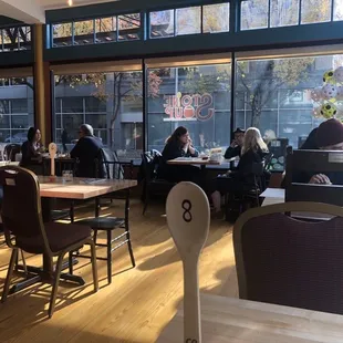 people sitting at tables in a restaurant