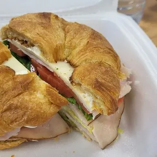 Turkey, avocado, cheese, lettuce, tomato, and mayo on a croissant. Yum!