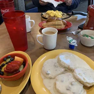 Fresh fruit, biscuits and sausage gravy, stoneware skillet, sourdough toast
