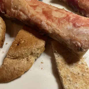 Undercooked bone marrow bottoms and heel of bread.