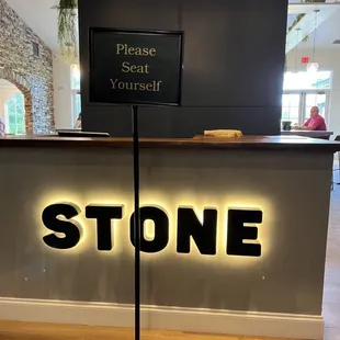 a sign that says please seat yourself
