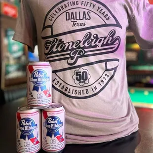 three cans of beer on a table