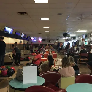 Lots of happy people who are bowling, eating, drinking and being social without this freakin phone I am holding.