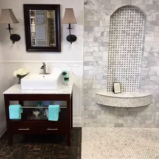 Showroom vignettes with natural Carrara marble on the right and ceramic Carrara look on the left