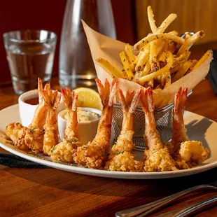 a plate of fried shrimp and fries