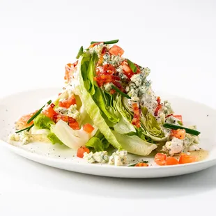 a plate of salad with lettuce and tomatoes