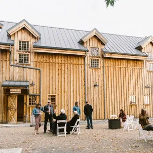 a group of people outside a barn