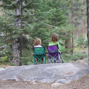 My girls sitting looking at the creek before breakfast.