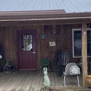the front porch of a rustic cabin