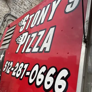 a delivery truck parked in front of a brick building