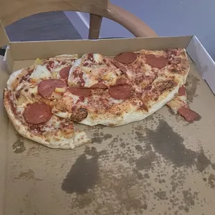 a half eaten pepperoni pizza