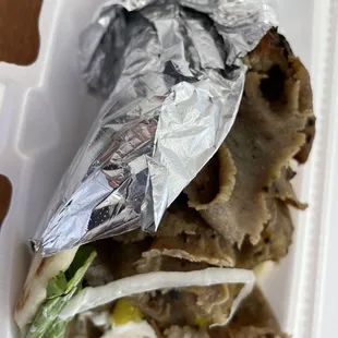a wrap of food in a styrofoam container