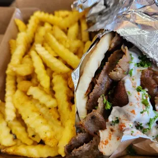 Lamb gyro with a side of crinkle fries.