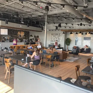people sitting at tables in a coffee shop