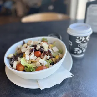 a bowl of salad and a cup of coffee