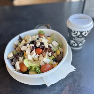 a bowl of salad and a cup of coffee