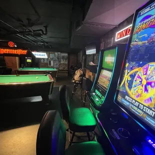 a pool table and arcade machines