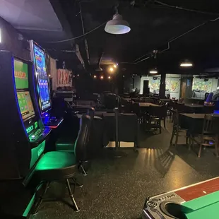 a gaming room with tables and chairs