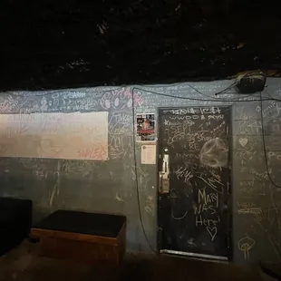 a dark room with graffiti on the walls