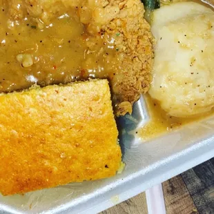 a meal of fried chicken, mashed potatoes, and gravy