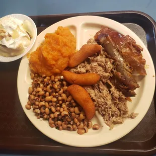 Sweet potatoes, black eyed peas, ribs, pulled pork, hush puppies, and banana pudding.