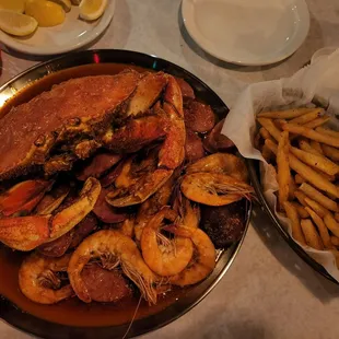 Create your own combo, "mix all three sauces, hot": Dungeness, shrimp, double sausage and potatoes with fries