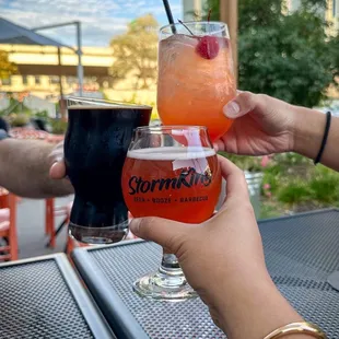 two people toasting with drinks