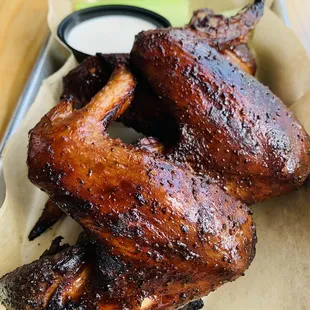 a plate of chicken wings with dipping sauce