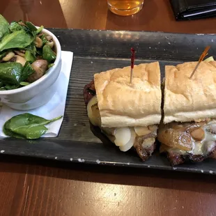 Rib eye sandwich with sautéed spinach and mushrooms