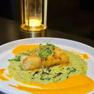 MISO GLAZED CHILEAN SEA BASS  Miso glazed roasted sea bass* filet, ginger carrot purée, wasabi pearl couscous, sautéed spinach