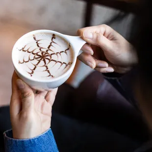 a woman holding a cup of coffee