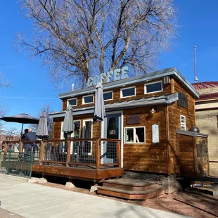 a coffee shop with a tree in the background
