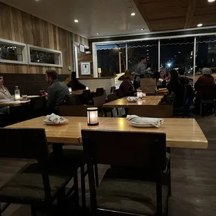 people sitting at tables in a restaurant