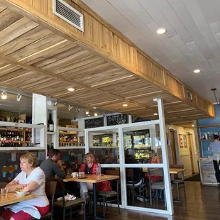 people sitting at tables in a restaurant