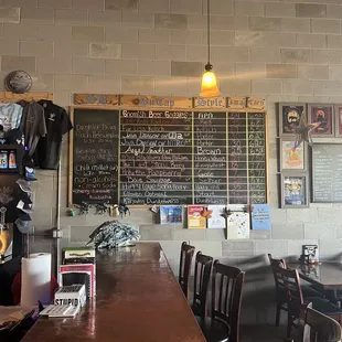 a bar with a chalkboard on the wall